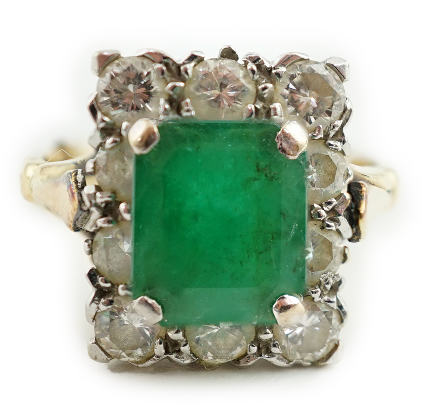 An 18ct gold and platinum, emerald and diamond rectangular cluster ring